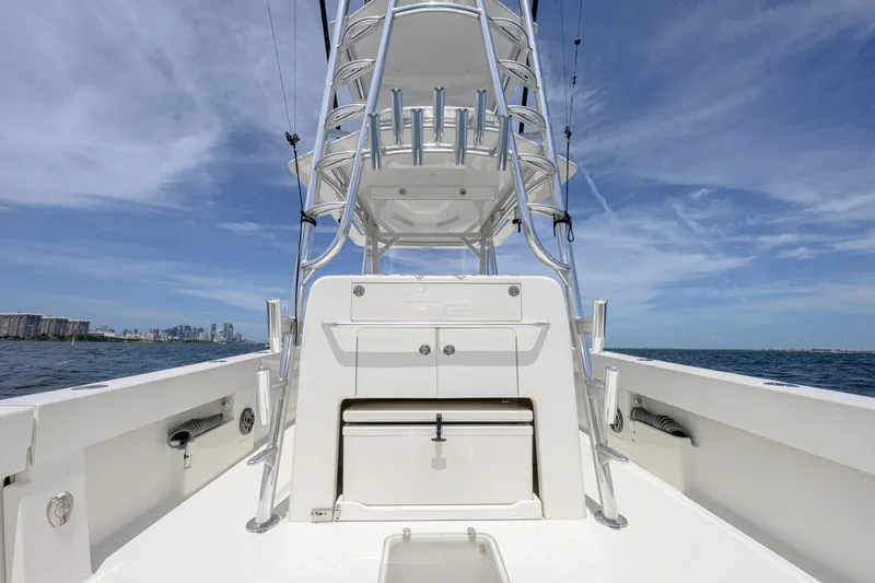 39z Yacht Photos Pics 2017 SeaVee 390 boat with tower, ocean view, and city skyline in the background.