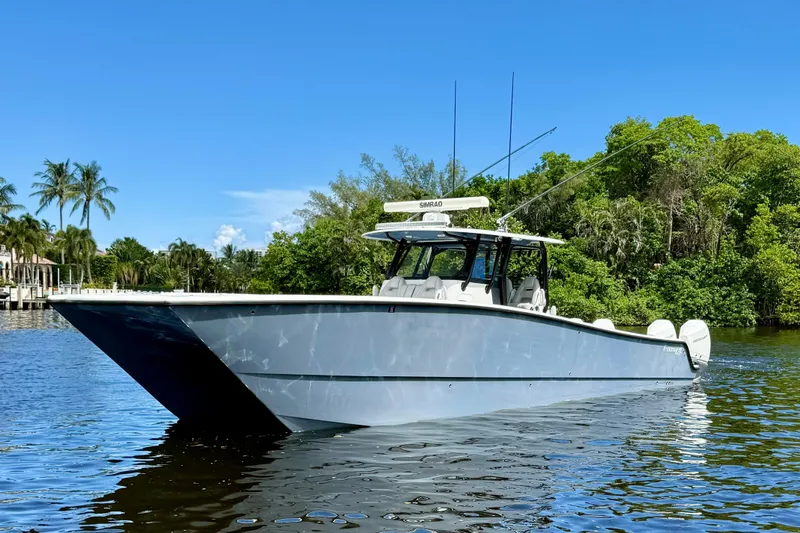  Yacht Photos Pics 2019 Freeman 42 LR boat on a calm river, surrounded by lush greenery.