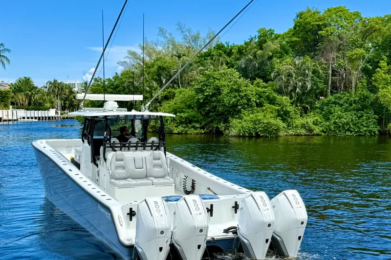  Yacht Photos Pics 2019 Freeman 42 LR boat cruising on a scenic river with lush greenery.