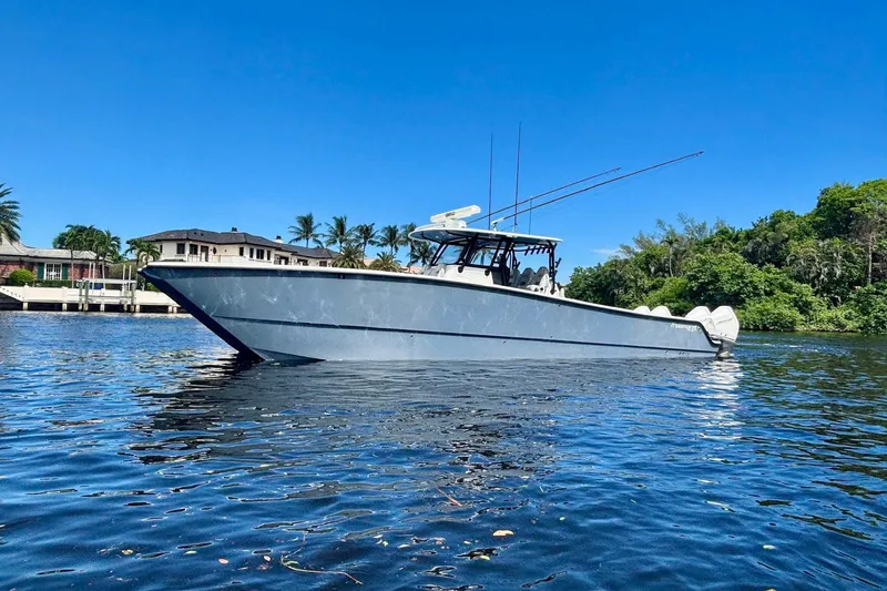  Yacht Photos Pics 2019 Freeman 42 LR boat on water, clear sky, lush greenery, and waterfront homes.