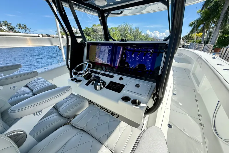  Yacht Photos Pics Luxurious 2019 Freeman 42 LR boat cockpit with advanced navigation system and plush seating.