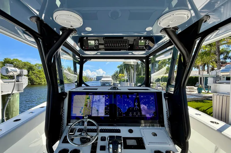  Yacht Photos Pics Interior view of 2019 Freeman 42 LR boat cockpit with navigation screens and steering wheel.