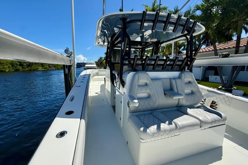  Yacht Photos Pics 2019 Freeman 42 LR boat with luxurious seating, docked by a scenic waterway.