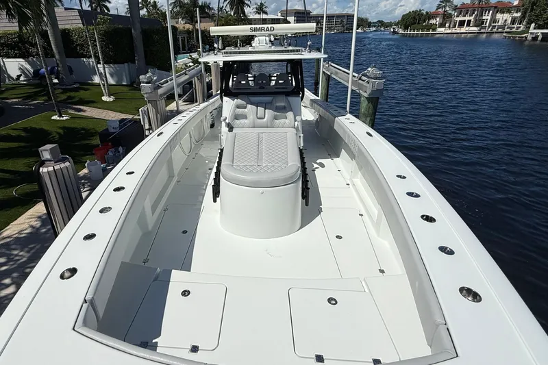  Yacht Photos Pics 2019 Freeman 42 LR boat docked by waterfront, featuring spacious deck and seating.
