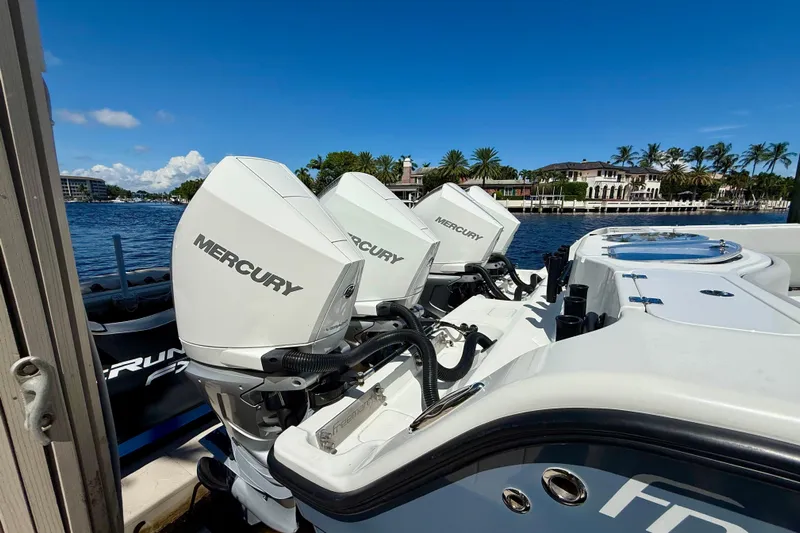  Yacht Photos Pics 2019 Freeman 42 LR boat with Mercury outboard engines docked by waterfront homes.