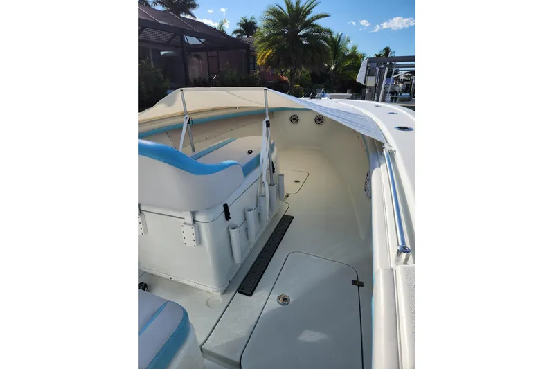 Rock N Reel Yacht Photos Pics 2018 Yellowfin 36 Offshore boat interior with seating and canopy, surrounded by tropical scenery.