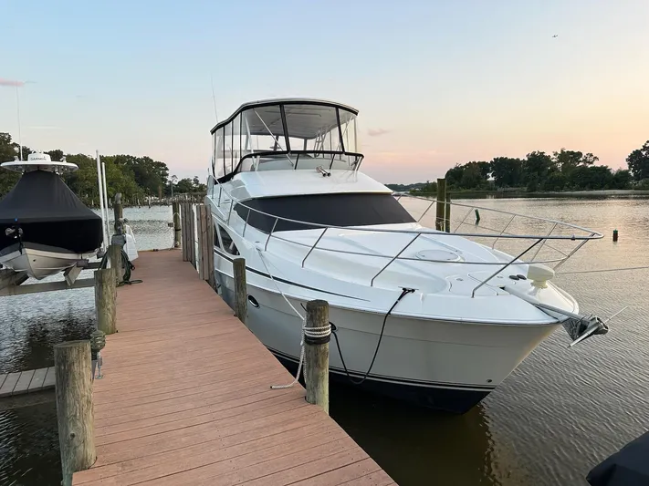  Yacht Photos Pics 2005 Silverton 38 Sport Bridge yacht docked at sunset.