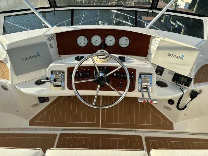  Yacht Photos Pics 2005 Silverton 38 Sport Bridge helm with Garmin navigation and classic wood accents.