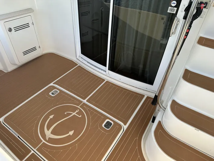  Yacht Photos Pics 2005 Silverton 38 Sport Bridge deck with anchor design and sliding glass door.