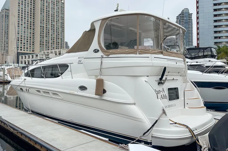 Pan-a-sea-ahh Yacht Photos Pics 2004 Sea Ray 390 Motor Yacht docked in a marina with cityscape background.