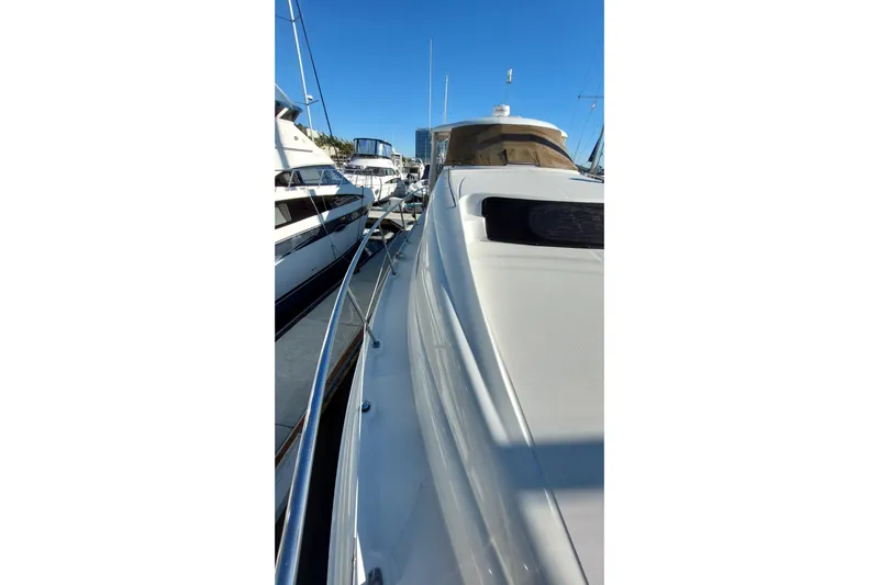 Pan-a-sea-ahh Yacht Photos Pics 2004 Sea Ray 390 Motor Yacht docked, side view with clear blue sky.