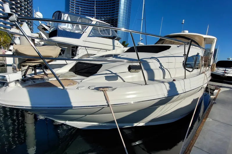 Pan-a-sea-ahh Yacht Photos Pics 2004 Sea Ray 390 Motor Yacht docked at marina, clear blue sky background.