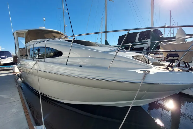 Pan-a-sea-ahh Yacht Photos Pics 2004 Sea Ray 390 Motor Yacht docked at marina under clear blue sky.