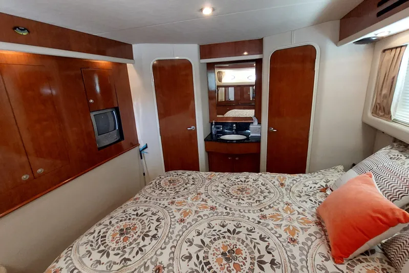 Pan-a-sea-ahh Yacht Photos Pics Luxurious 2004 Sea Ray 390 Motor Yacht bedroom with elegant wood finishes and cozy bedding.