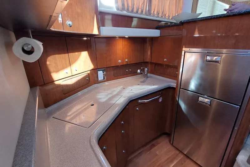 Pan-a-sea-ahh Yacht Photos Pics Luxurious 2004 Sea Ray 390 Motor Yacht kitchen with wood cabinetry and stainless steel appliances.