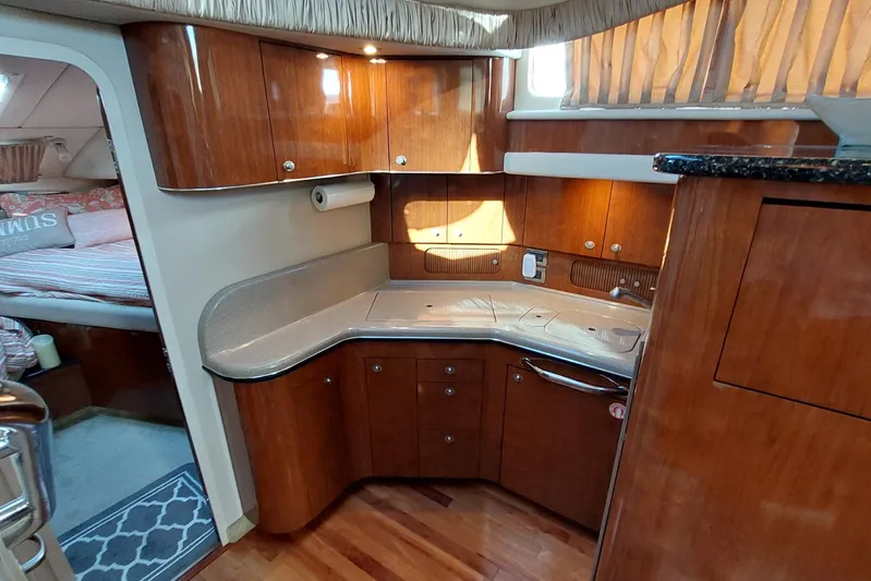 Pan-a-sea-ahh Yacht Photos Pics Luxurious 2004 Sea Ray 390 Motor Yacht interior with elegant wood cabinetry and cozy sleeping area.
