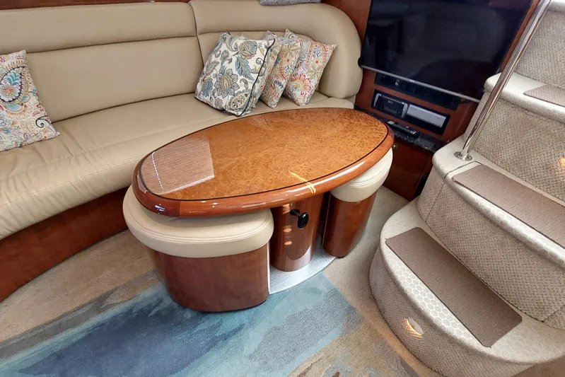 Pan-a-sea-ahh Yacht Photos Pics Luxurious interior of 2004 Sea Ray 390 Motor Yacht with elegant seating and wooden table.