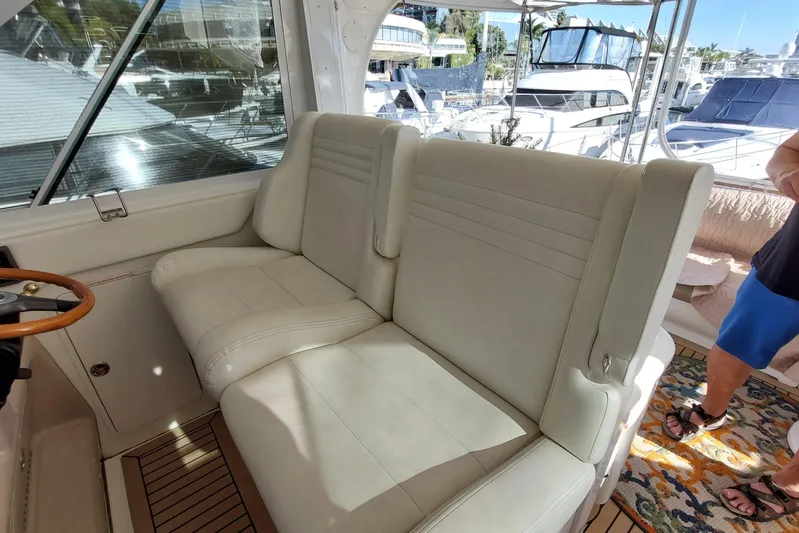 Pan-a-sea-ahh Yacht Photos Pics 2004 Sea Ray 390 Motor Yacht interior with white seating and wooden accents.