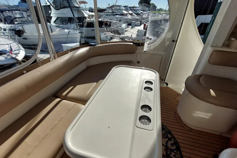 Pan-a-sea-ahh Yacht Photos Pics Interior of 2004 Sea Ray 390 Motor Yacht with seating and table, docked at marina.