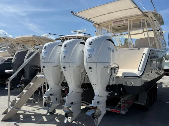 335-514 Brokerage Ron Yacht Photos Pics 2023 Grady-White Freedom 335 boat with triple Yamaha outboard engines on a trailer.