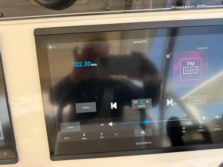 335-514 Brokerage Ron Yacht Photos Pics Garmin display on 2023 Grady-White Freedom 335 showing FM radio at 102.30 MHz.