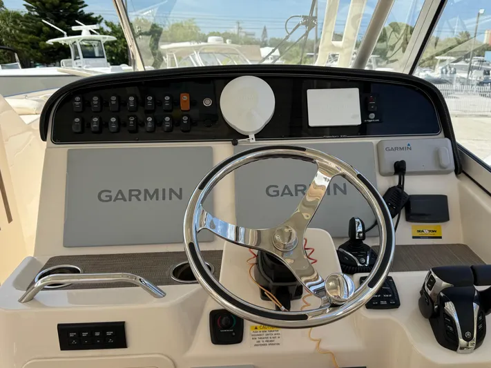 335-514 Brokerage Ron Yacht Photos Pics 2023 Grady-White Freedom 335 helm with Garmin electronics and steering wheel.