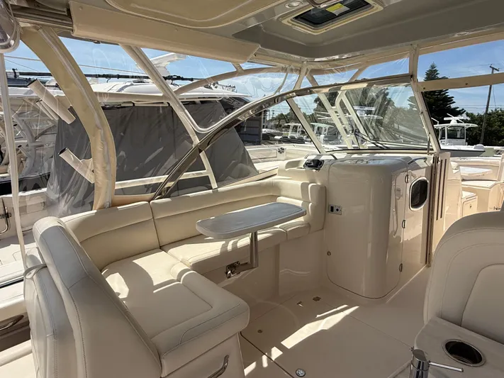 335-514 Brokerage Ron Yacht Photos Pics 2023 Grady-White Freedom 335 boat interior with beige seating and table.