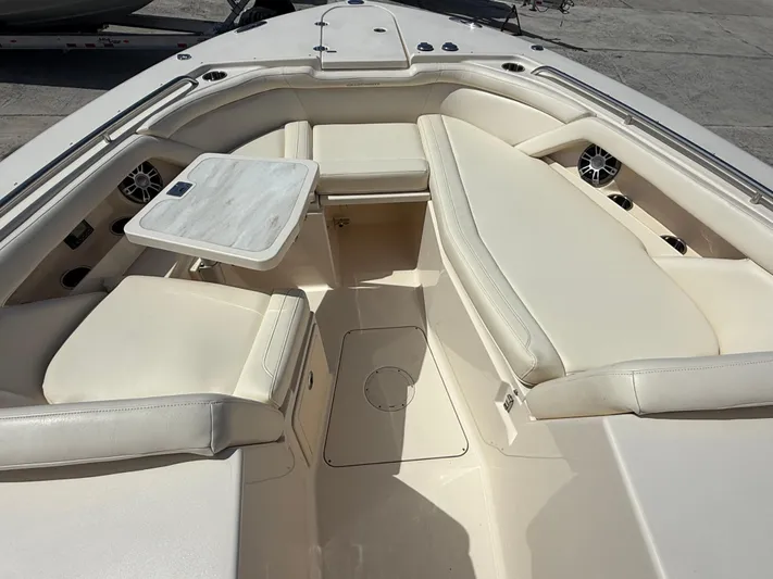 335-514 Brokerage Ron Yacht Photos Pics 2023 Grady-White Freedom 335 boat interior with cushioned seating and table.