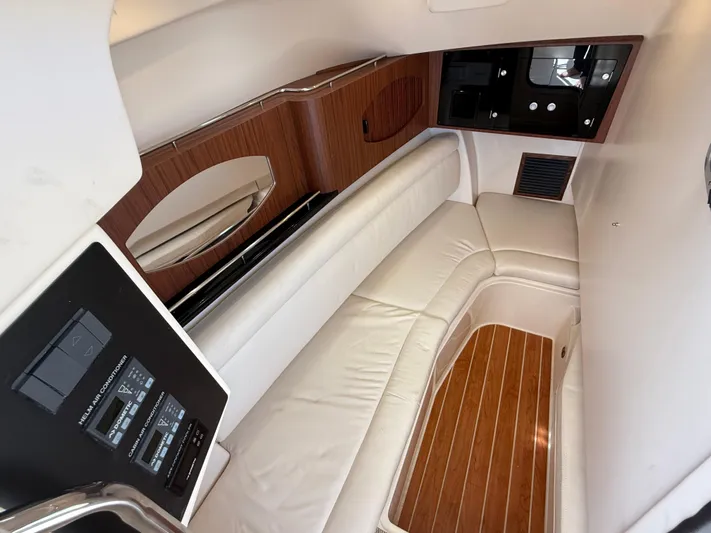 335-514 Brokerage Ron Yacht Photos Pics 2023 Grady-White Freedom 335 cabin interior with white seating and wood accents.