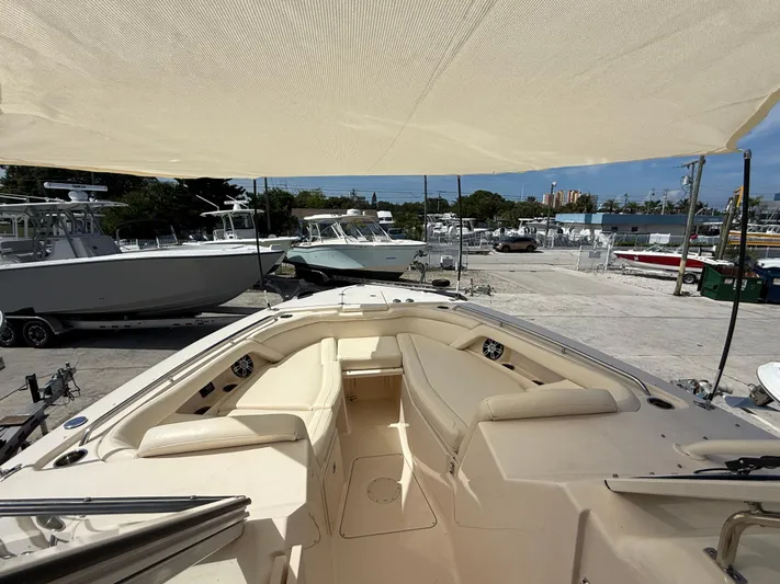 335-514 Brokerage Ron Yacht Photos Pics 2023 Grady-White Freedom 335 boat with spacious seating under a sunshade at a marina.