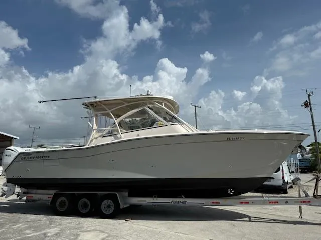  Yacht Photos Pics 2023 Grady-White Freedom 335 boat on trailer under cloudy sky.