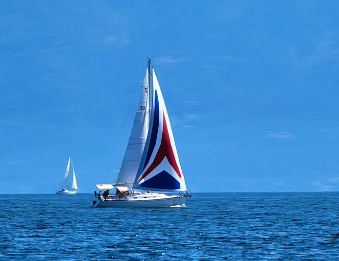 Celebration Yacht Photos Pics Sailboat Tartan 3400 (2007) with colorful spinnaker on open sea.
