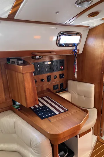 Celebration Yacht Photos Pics Interior of 2007 Tartan 3400 sailboat with navigation station and American flag decor.