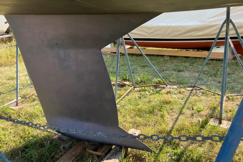 Celebration Yacht Photos Pics Keel of a 2007 Tartan 3400 sailboat on a stand outdoors.