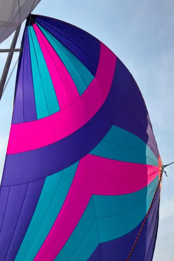 Celebration Yacht Photos Pics Colorful sail of a 2007 Tartan 3400 yacht against a clear sky.