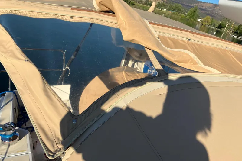 Celebration Yacht Photos Pics Tartan 3400 sailboat cockpit with beige canopy, reflecting water and landscape, 2007 model.