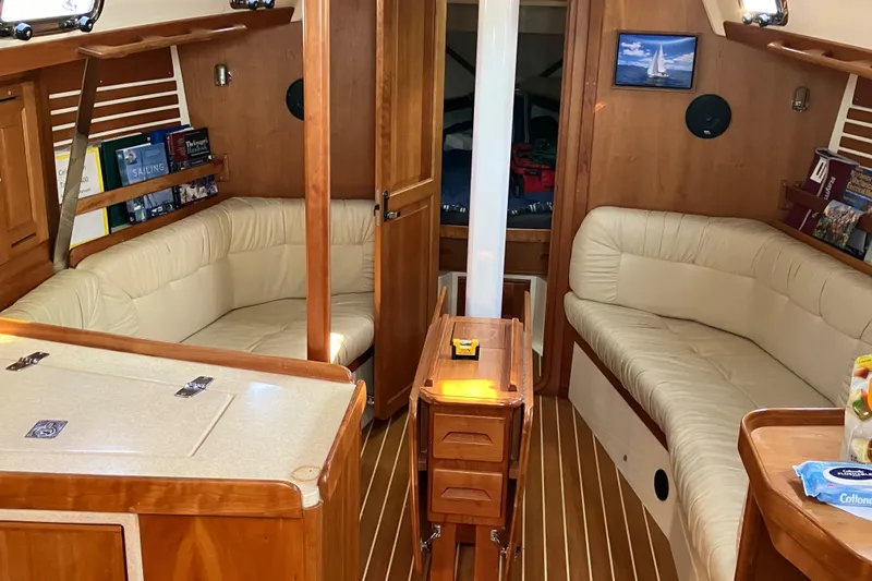 Celebration Yacht Photos Pics Interior of 2007 Tartan 3400 sailboat with wooden finish and cozy seating.