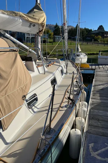 Celebration Yacht Photos Pics 2007 Tartan 3400 sailboat docked, featuring beige covers and sleek design.