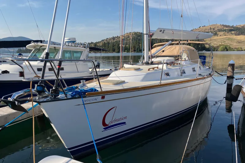 Celebration Yacht Photos Pics Sailboat docked in marina, Tartan 3400, 2007 model, calm water, scenic background.