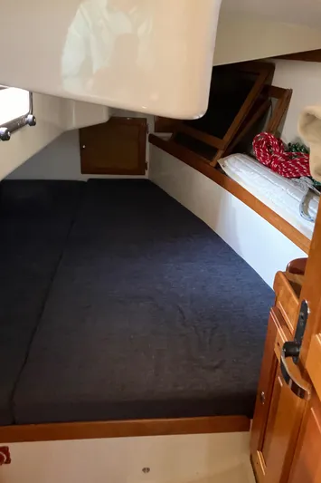 Celebration Yacht Photos Pics Interior cabin of a 2007 Tartan 3400 sailboat with a cozy sleeping area.