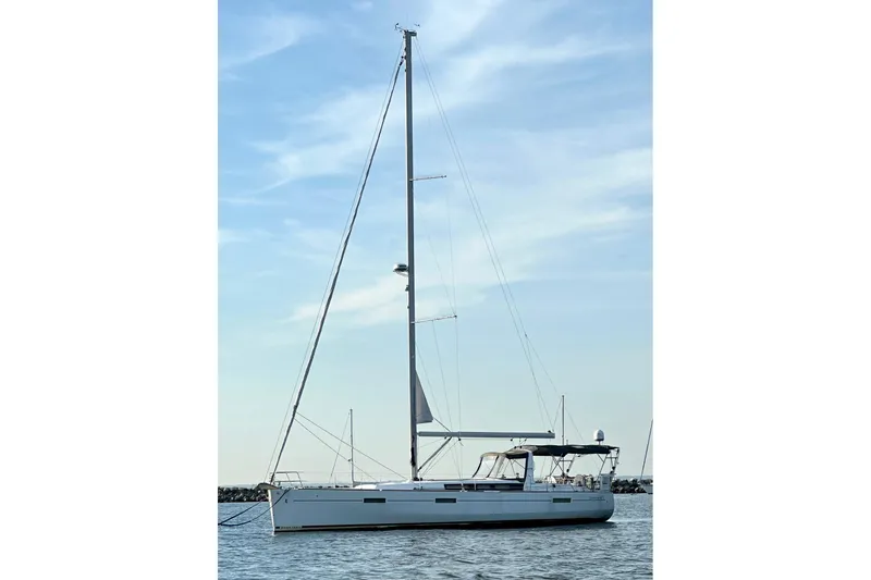  Yacht Photos Pics 2017 Beneteau Oceanis 45 sailboat on calm water under a clear sky.