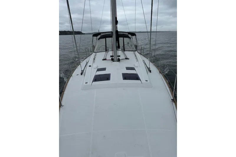  Yacht Photos Pics 2017 Beneteau Oceanis 45 sailboat on calm waters, overcast sky.