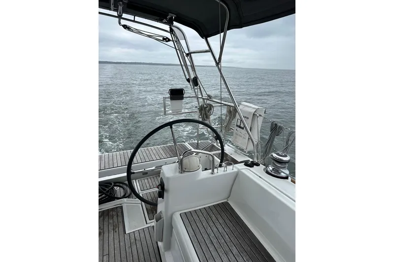  Yacht Photos Pics Cockpit view of 2017 Beneteau Oceanis 45 sailing on open water.