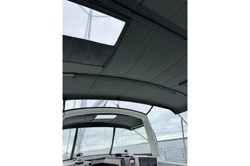  Yacht Photos Pics 2017 Beneteau Oceanis 45 yacht cockpit with canopy, overlooking calm sea.