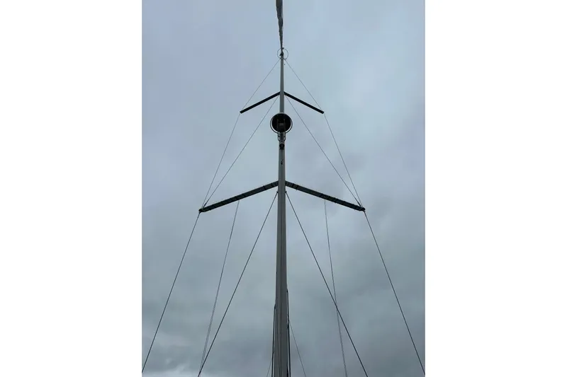  Yacht Photos Pics Mast of 2017 Beneteau Oceanis 45 sailboat against cloudy sky.