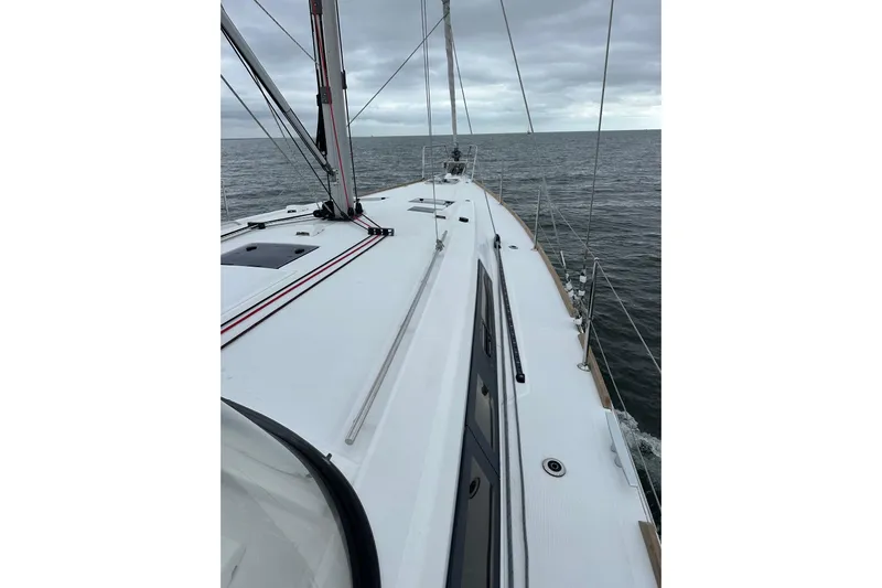  Yacht Photos Pics 2017 Beneteau Oceanis 45 sailboat on open sea under cloudy skies.