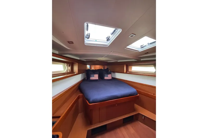  Yacht Photos Pics Luxurious cabin interior of 2017 Beneteau Oceanis 45 yacht with skylights and cozy bedding.