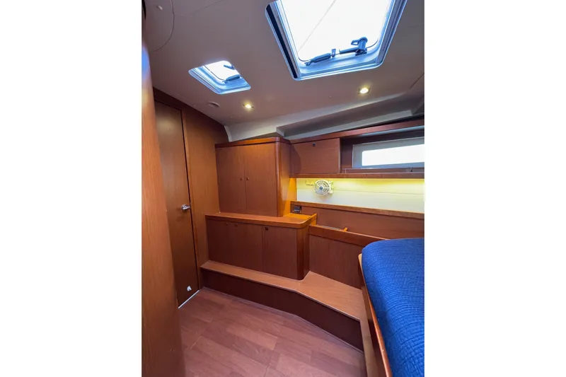  Yacht Photos Pics Interior cabin of 2017 Beneteau Oceanis 45 yacht with wood finish and skylight.