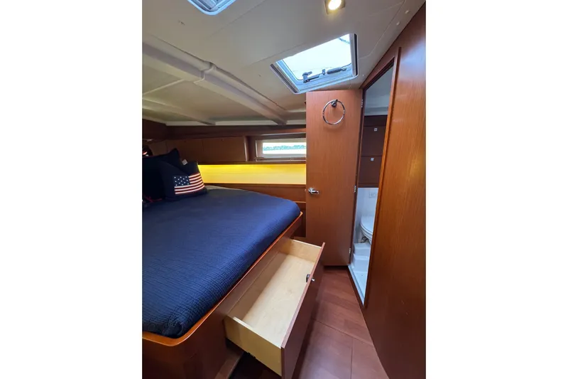  Yacht Photos Pics Cozy cabin interior of 2017 Beneteau Oceanis 45 yacht with bed and storage.