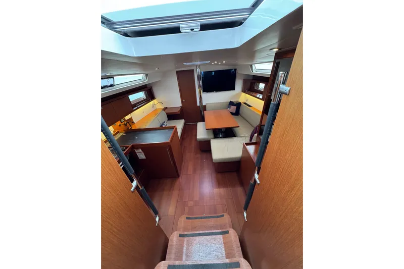  Yacht Photos Pics Interior of 2017 Beneteau Oceanis 45 yacht, featuring modern wood finish and cozy seating area.